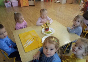 Dzieci prezentują owocowe szaszłyki.