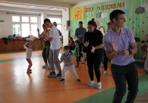 Dzieci tańczą razem z rodzicami.